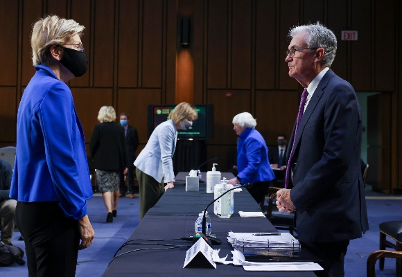 Sen. Elizabeth Warren, D-Mass., talks to Federal Reserve Chairman Jerome Powell before a Senate Banking, Housing and Urban Affairs Committee hearing