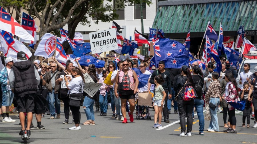 Freedom and Rights Coalition demonstrators march along Lambton Quay before gathering at Parliament, in Wellington, New Zealand