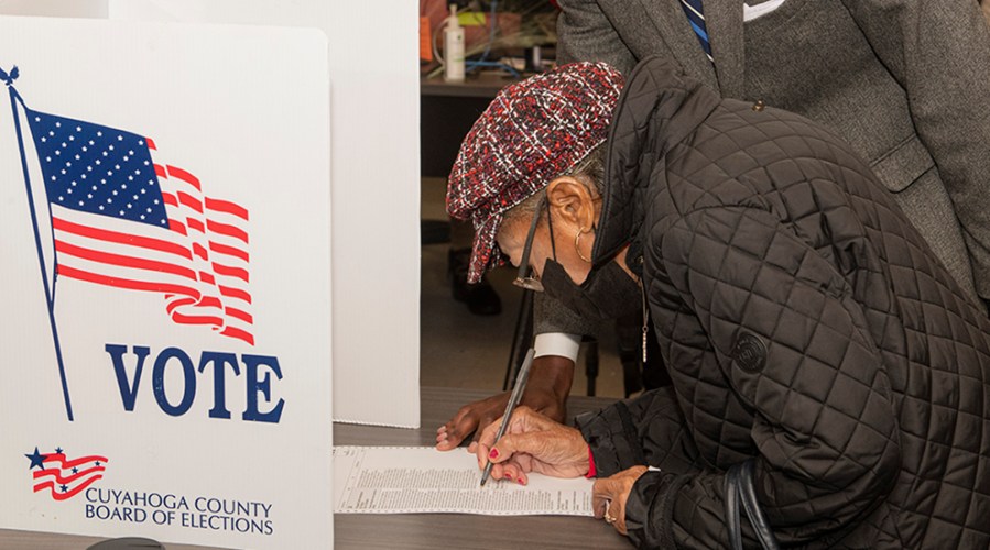 A woman fills out her ballot