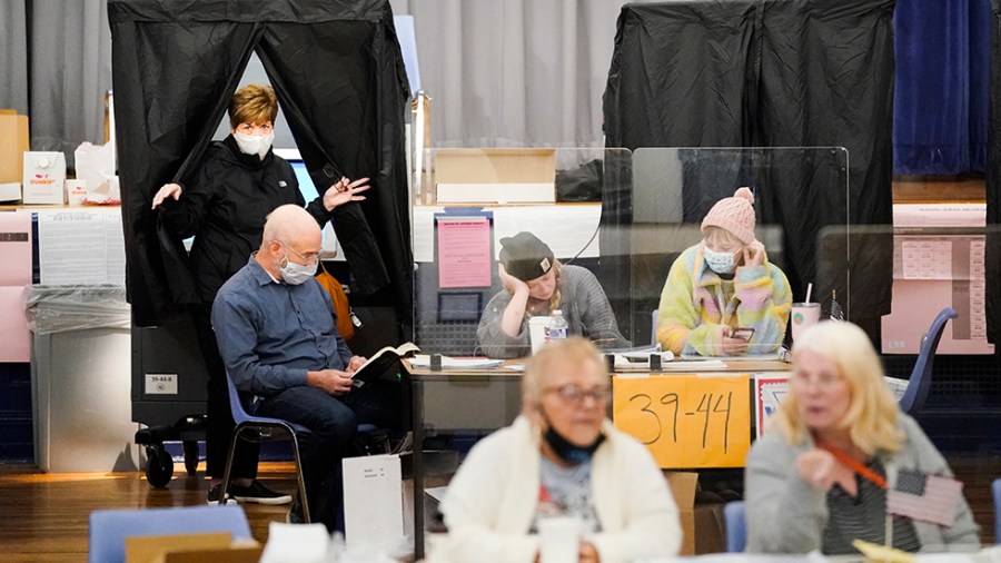 A woman walks out of a voting booth