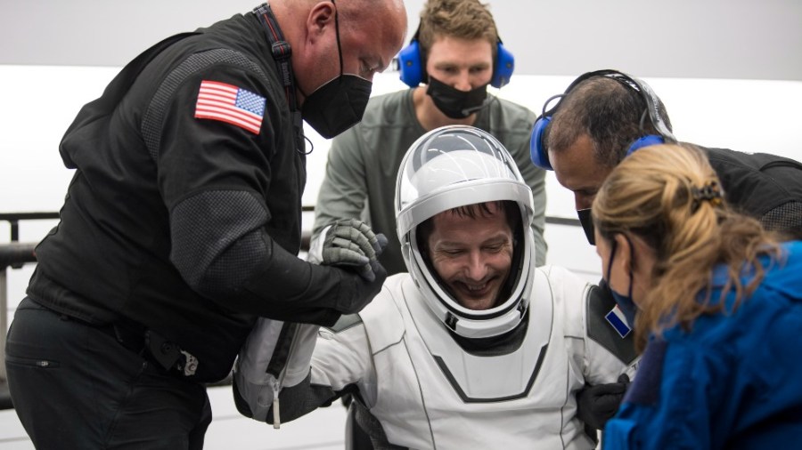 In this photo provided by NASA, European Space Agency astronaut Thomas Pesquet is helped out of the SpaceX Crew Dragon Endeavour spacecraft