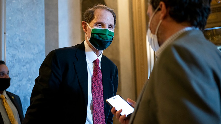 Sen. Ron Wyden (D-Ore.) speaks to a reporter following a Senate Democratic luncheon on Thursday, November 18, 2021 as the Senate discuss moving forward with debating the National Defense Authorization Act.