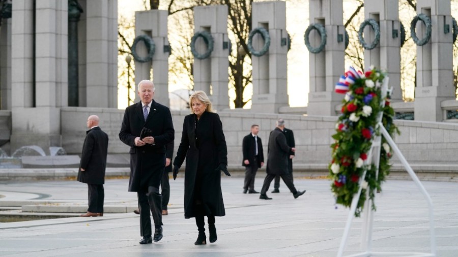 President Joe Biden and first lady Jill Biden walk towards a wreath and mark the 80th anniversary of the Japanese attack on Pearl Harbor with a visit to the World War II Memorial