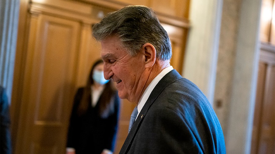 Sen. Joe Manchin (D-W.Va.) arrives to the Senate Chamber for procedural votes regarding nominations on Wednesday, December 8, 2021.