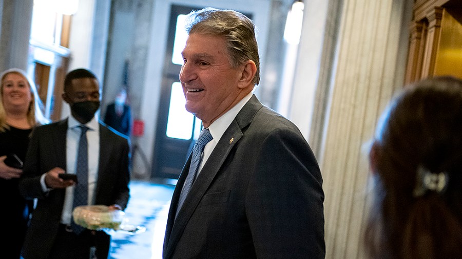 Sen. Joe Manchin (D-W.Va.) arrives to the Senate Chamber for procedural votes regarding nominations on Wednesday, December 8, 2021.