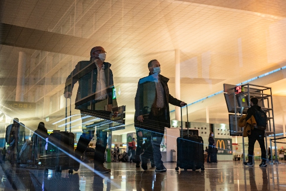 Passengers walk inside a terminal of the Barcelona Airport