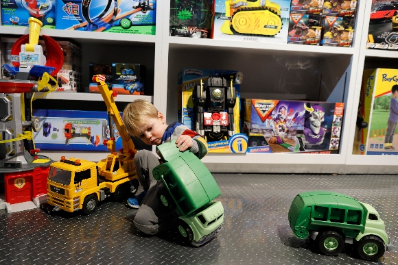 Maxwell MacIsaac, 2, plays with trucks at Camp toy store in New York