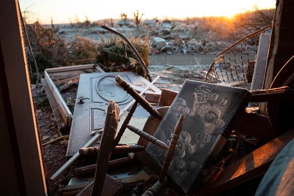 A family photo lays among the debris inside of a house after a tornado in Dawson Springs, Ky.