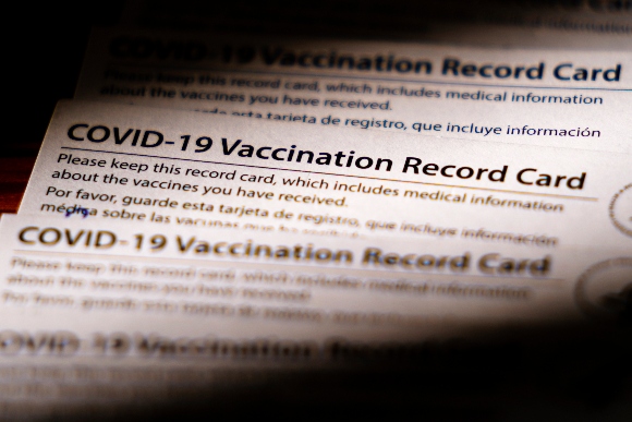 Shown are COVID-19 vaccination record cards