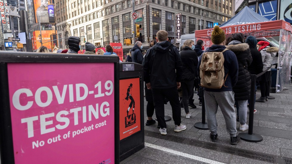 People wait in line to get tested for COVID-19 at a mobile testing site in Times Square