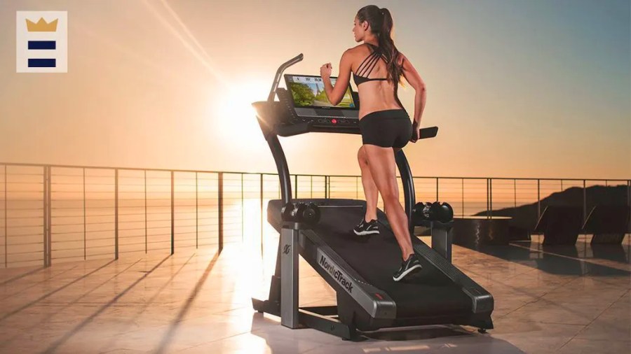 Woman running on a treadmill in front of a beautiful sunrise