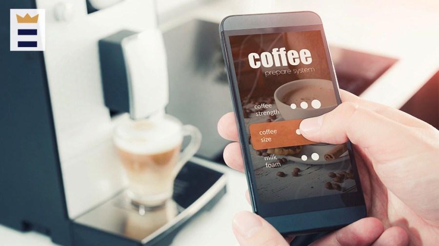 Person using their smartphone to talk to their smart coffee maker