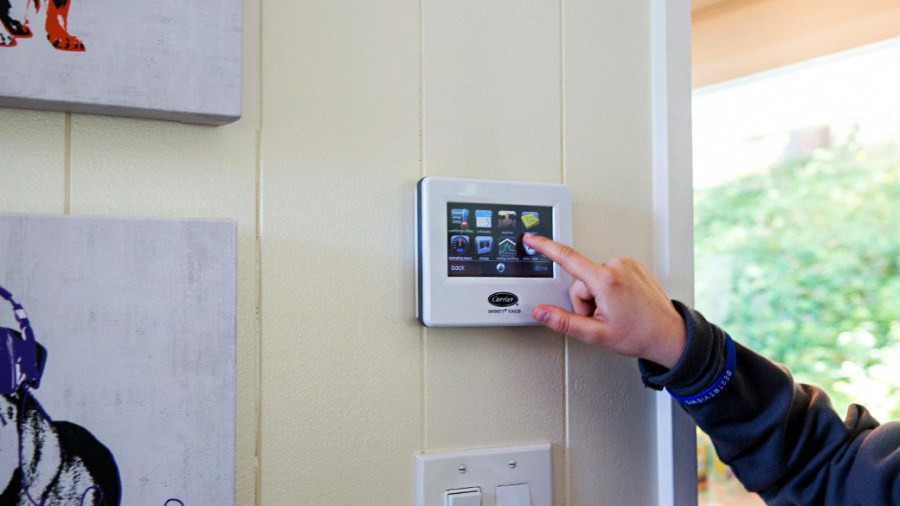 Person using the wall control for their smart home