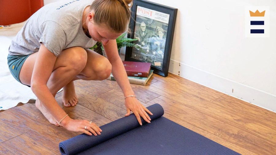 Person rolling up a yoga mat