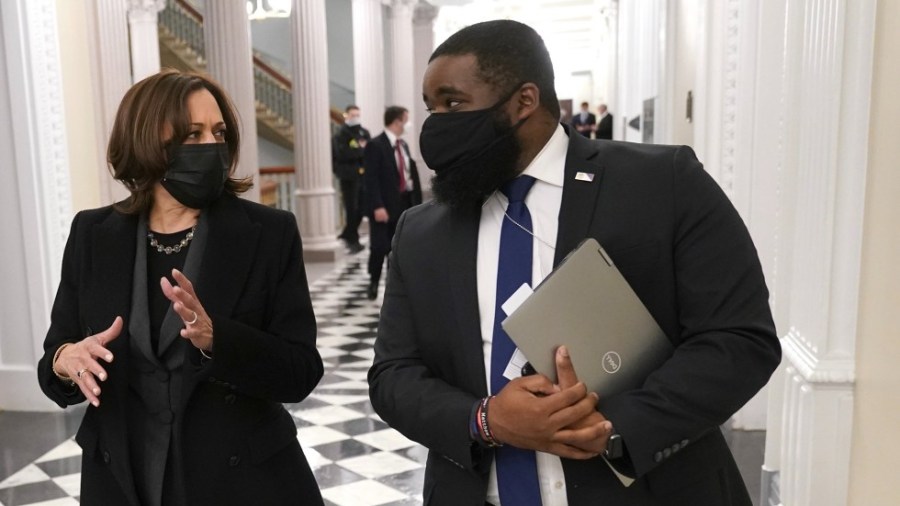 Vincent Evans walks with Vice President Harris