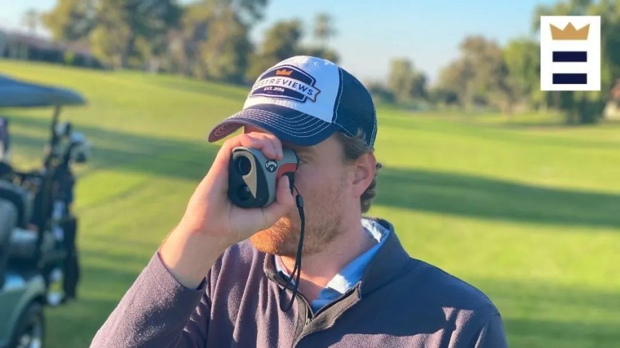 Man with a beard using a rangefinder