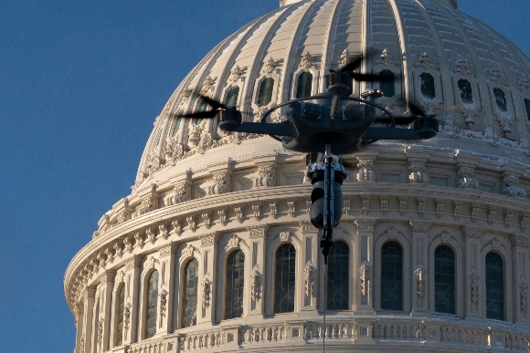 An Unmanned Aircraft System (UAS) tethered to a truck hovers near the U.S. Capitol