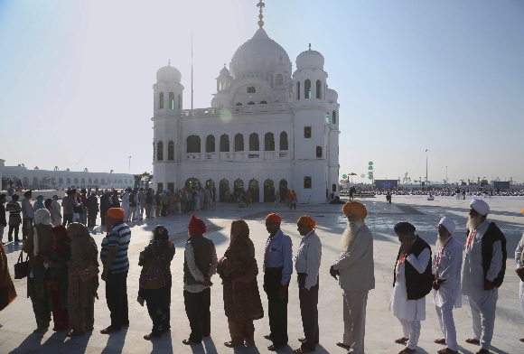 Sikh pilgrims visit the shrine of their spiritual leader Guru Nanak Dev