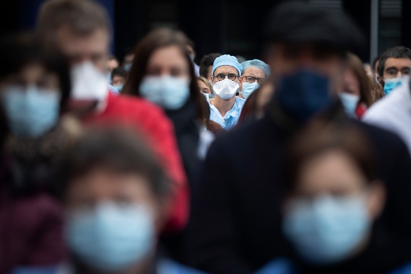 Medical staff observe a minute of silence while protesting a lack of resources