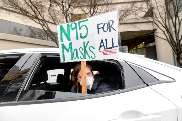 Elementary school teacher Carrie Landheer protests for stronger COVID-19 safety protocols