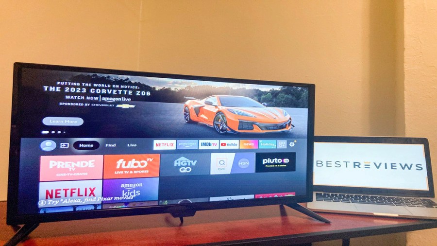 Flat screen television and laptop computer sitting on a table