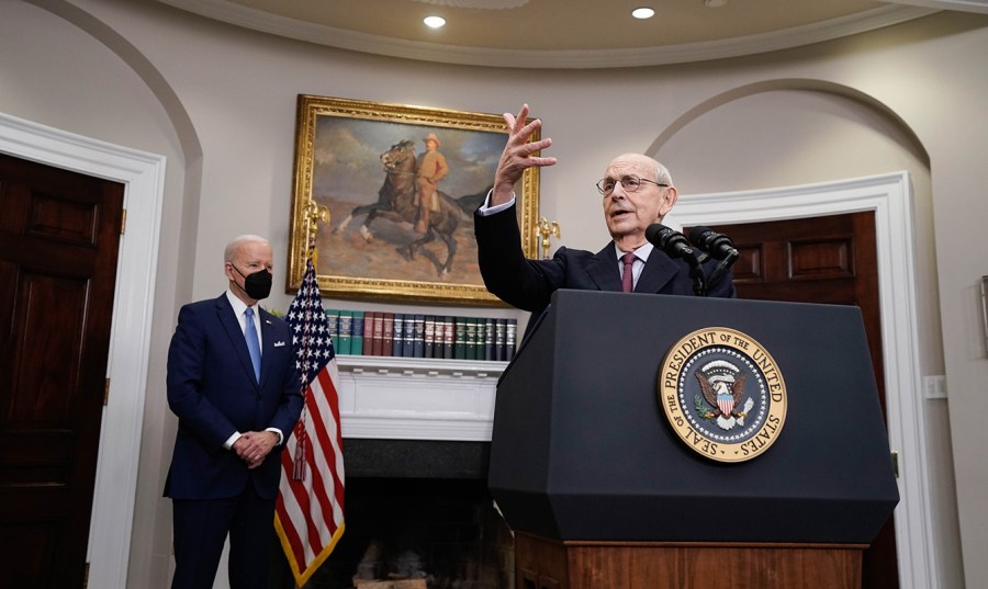 Supreme Court Justice Stephen Breyer gestures as he announces his retirement with President Biden in the background of the Roosevelt Room