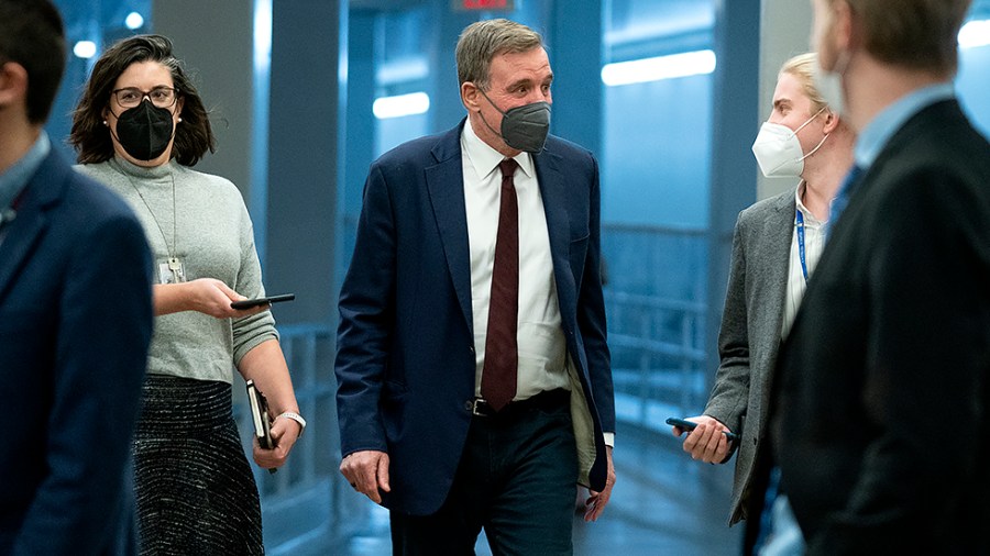 Sen. Mark Warner (D-Va.) speaks to reporters as he arrives to the Capitol for a cloture vote regarding a nomination on Wednesday, January 5, 2022.