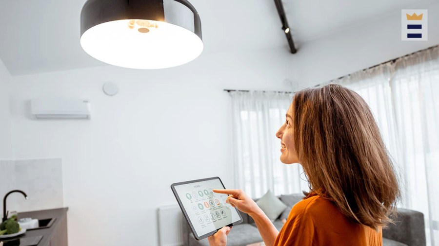 Woman controling an overhead room light with an app on her tablet