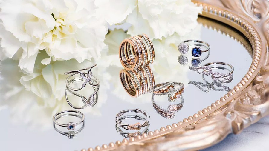 Several different styles of rings on a mirror-style tray