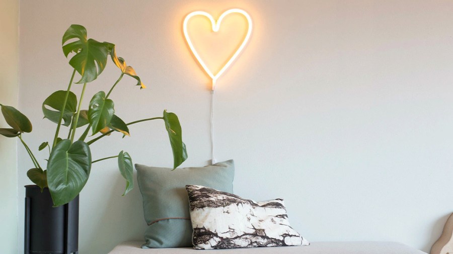 Neon heart displayed on a living room wall