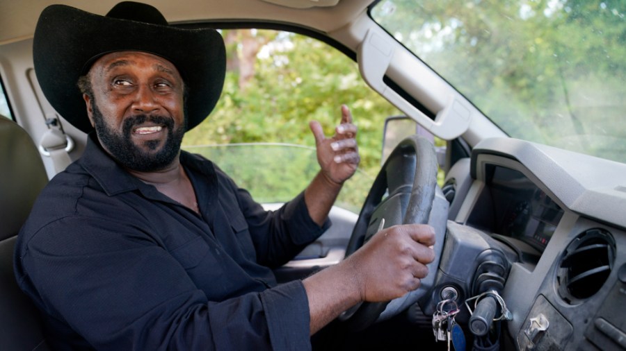 John Boyd Jr. drives his truck at his farm in Boydton, Va