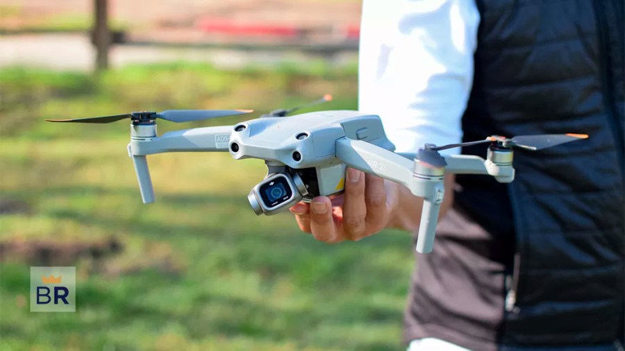 Person holding a white drone