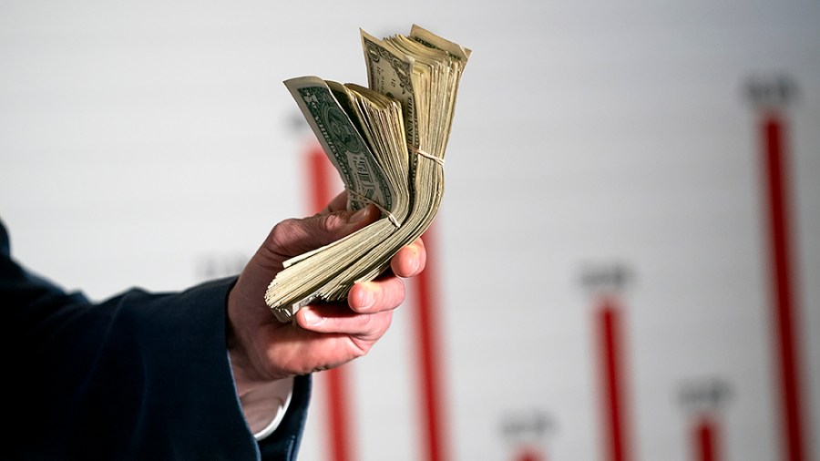 Sen. Roger Marshall (R-Kan.) holds a stack of dollar bills as he addresses reporters during a press conference on Wednesday, February 16, 2022 to discuss inflation during President Biden’s administration.