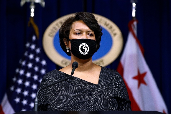 District of Columbia Mayor Muriel Bowser wears a face mask as she speaks at a news conference