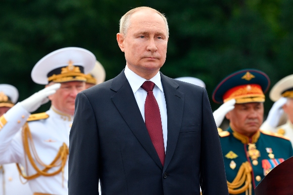 Russian President Vladimir Putin, center, delivers a speech