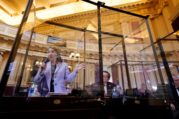 Virginia State Sen. Siobhan Dunnavant, R-Henrico, left, gestures from behind the Covid-19 shield on the floor of the Senate