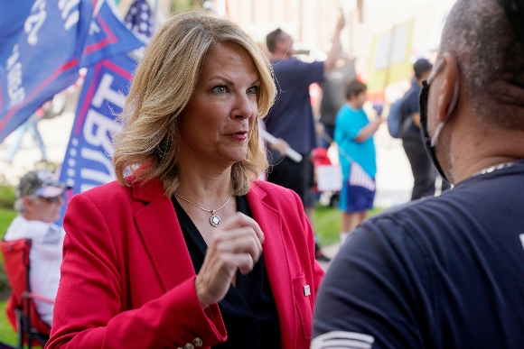 Dr. Kelli Ward, left, Chair of the Arizona Republican Party, talks with a supporter of President Donald Trump