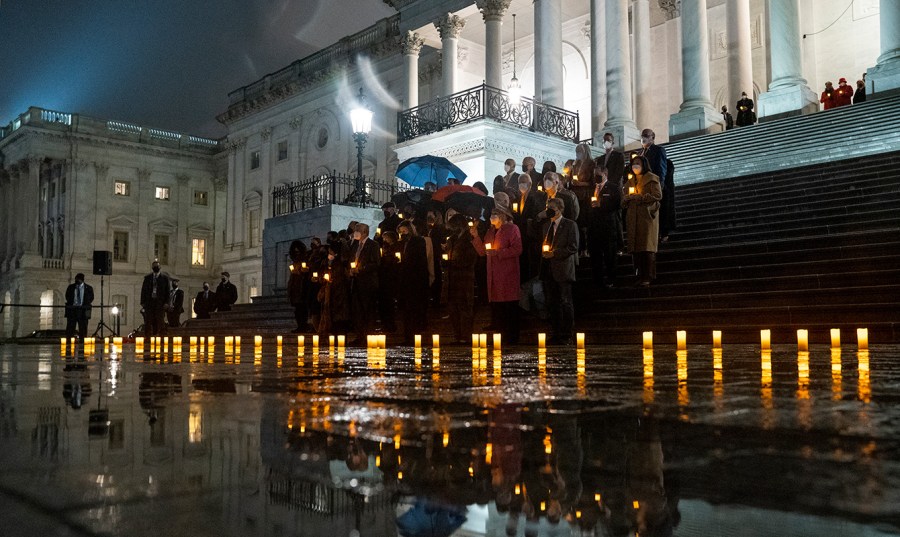 Members of Congress hold a moment of silence at the East Front steps of the Capitol.