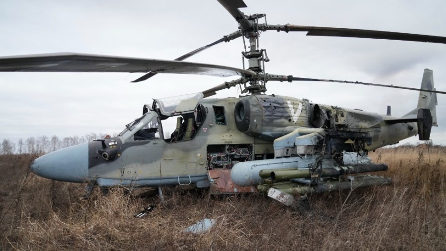 A Russian Ka-52 helicopter gunship is seen in the field after a forced landing outside Kyiv, Ukraine