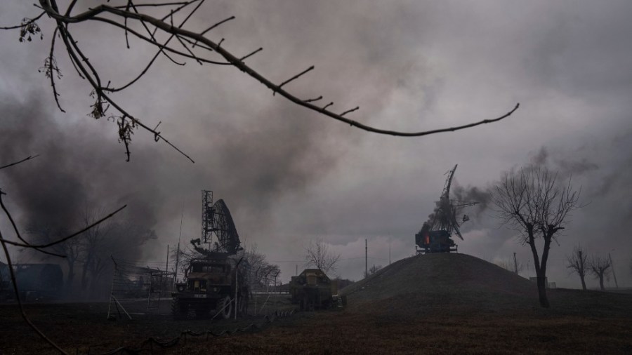 Smoke rises from an air defense base in the aftermath of an apparent Russian strike in Mariupol, Ukraine