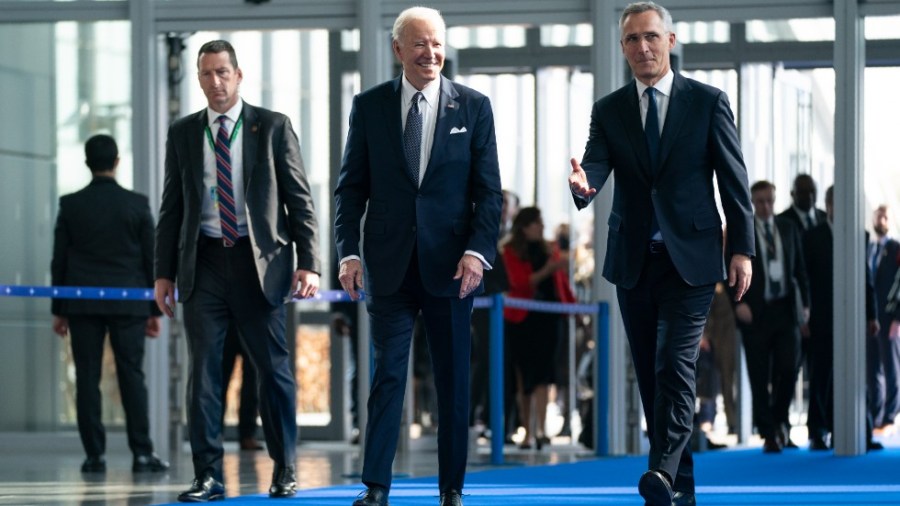 President Joe Biden walks with NATO Secretary General Jens Stoltenberg as he arrives for meetings with NATO allies about the Russian invasion of Ukraine