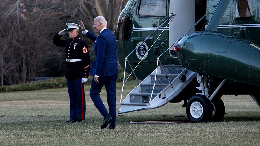 President Biden waves to guests on the South Lawn of the White House as he walks towards Marine One for a flight to Delaware for the weekend on Friday, March 4, 2022.