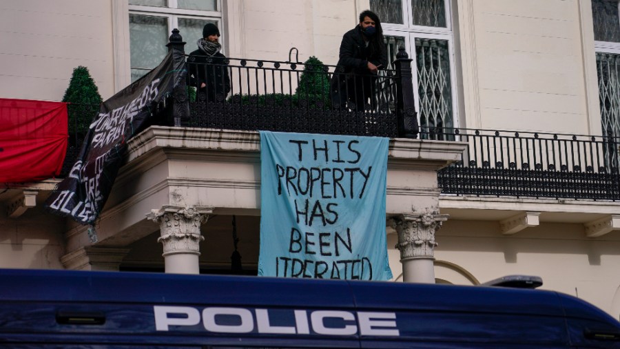 Squatters display banners and a Ukrainian flag as they occupy a London building believed to be owned by a Russian oligarch