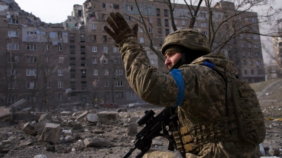 A Ukrainian serviceman guards his position in Mariupol, Ukraine, Saturday, March 12, 2022.