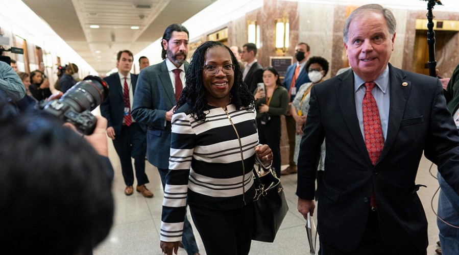 Supreme Court nominee Ketanji Brown Jackson and former Alabama Sen. Doug Jones walk in Capitol Hill