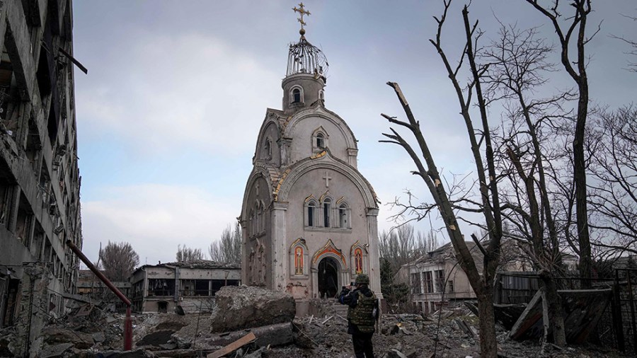 A man takes a photo of a damaged church in Mariupol, Ukraine.