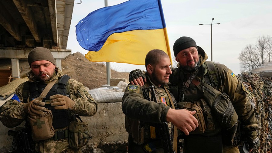 Ukrainian soldiers chat in the front-line position close to Kharkiv, Ukraine.