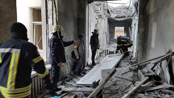 This handout photo released by Ukrainian Emergency Service shows emergency service personnel inspecting the damage inside the City Hall building in Kharkiv