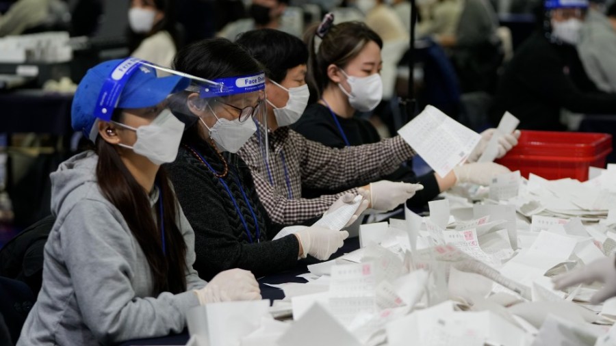 National Election Commission officials sort out ballots for counting in the presidential election in Seoul, South Korea