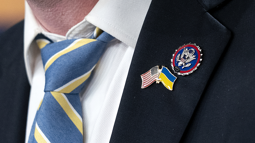 Rep. Brian Fitzpatrick (R-Pa.) wears a Ukrainian and American flag pin during a press conference on Thursday, March 3, 2022 to introduce the Banning Russian Energy Imports Act.